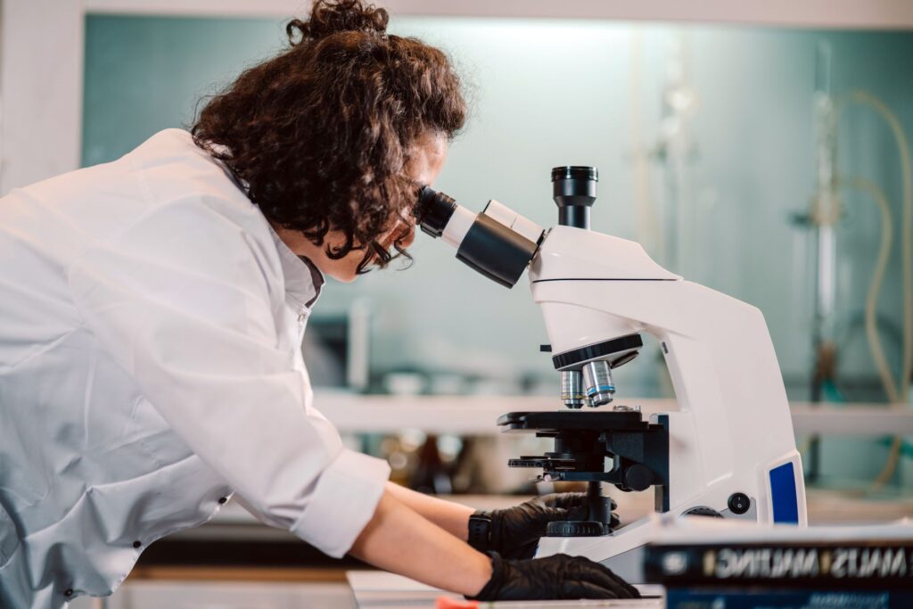 Scientist using a microscope in a laboratory