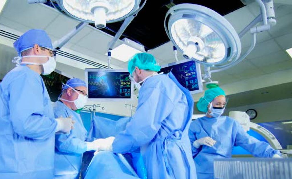 Surgical team in gowns and drapes in an operating room